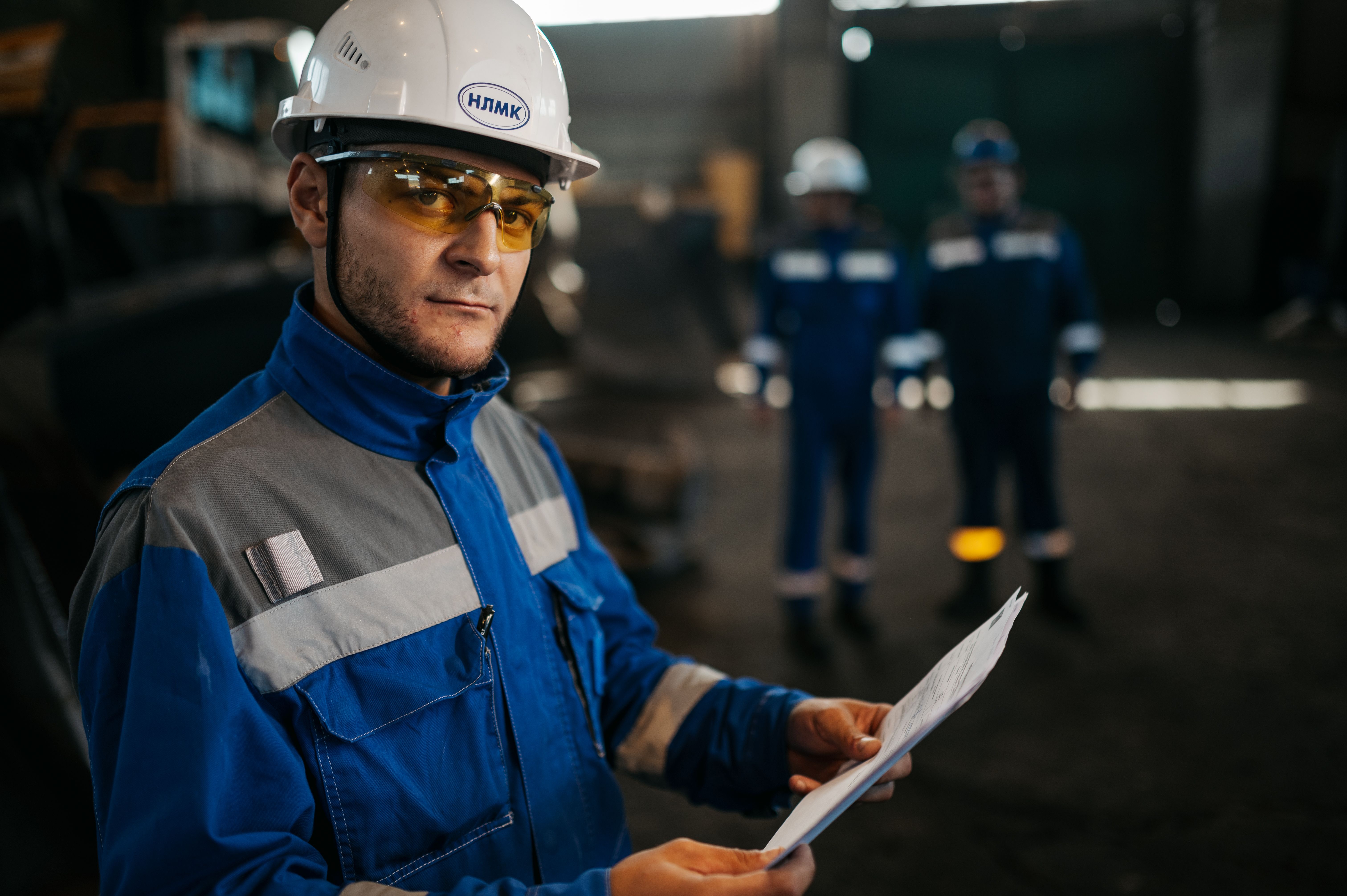 Industrial professionals reviewing project documentation on site